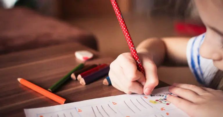 child writing at St Andrew's School