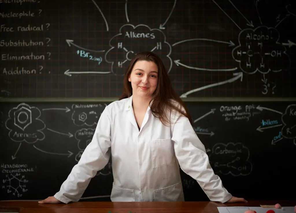 school girl in science lab coat