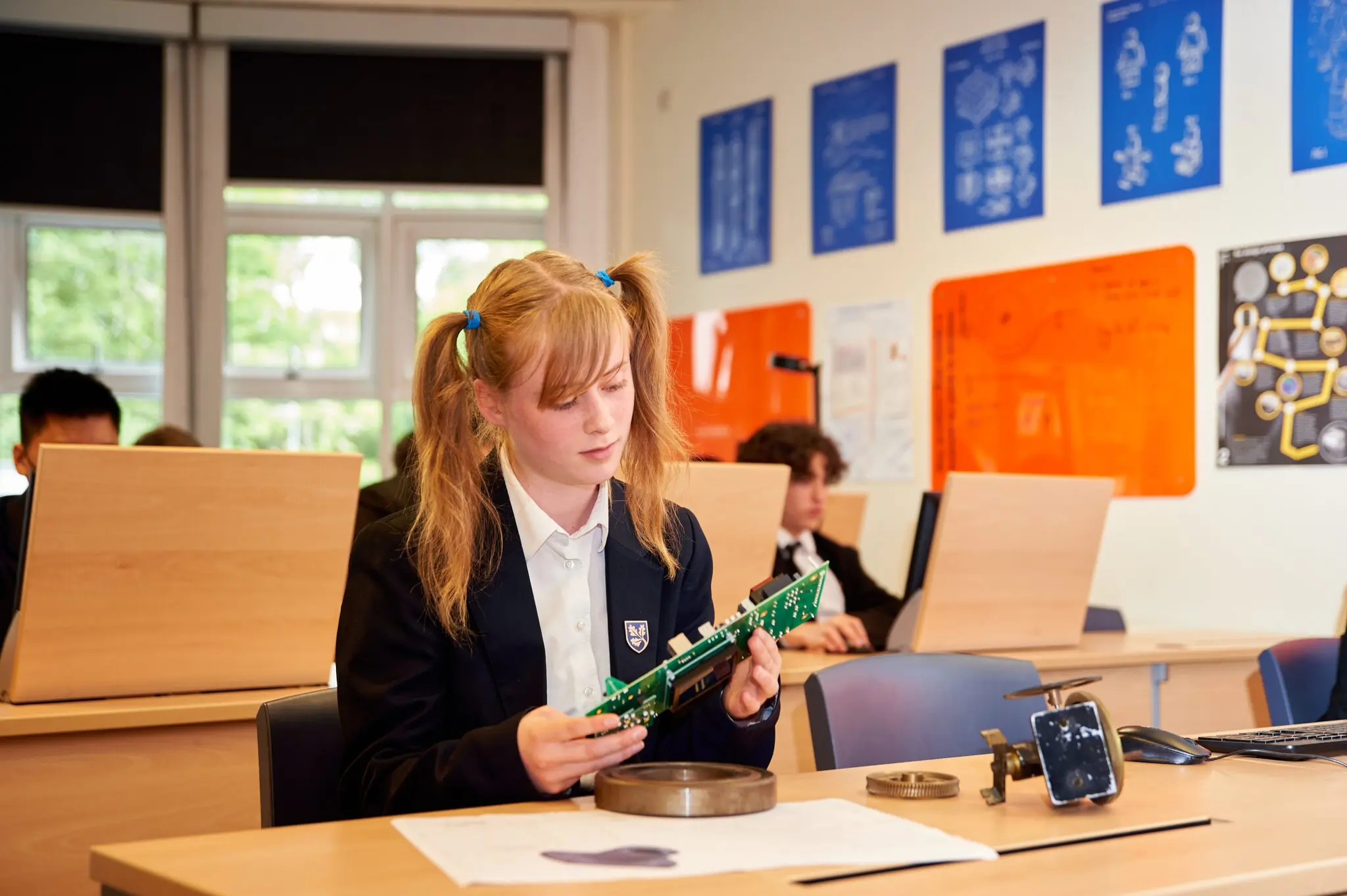 female Leighton Park student working with a circuit board