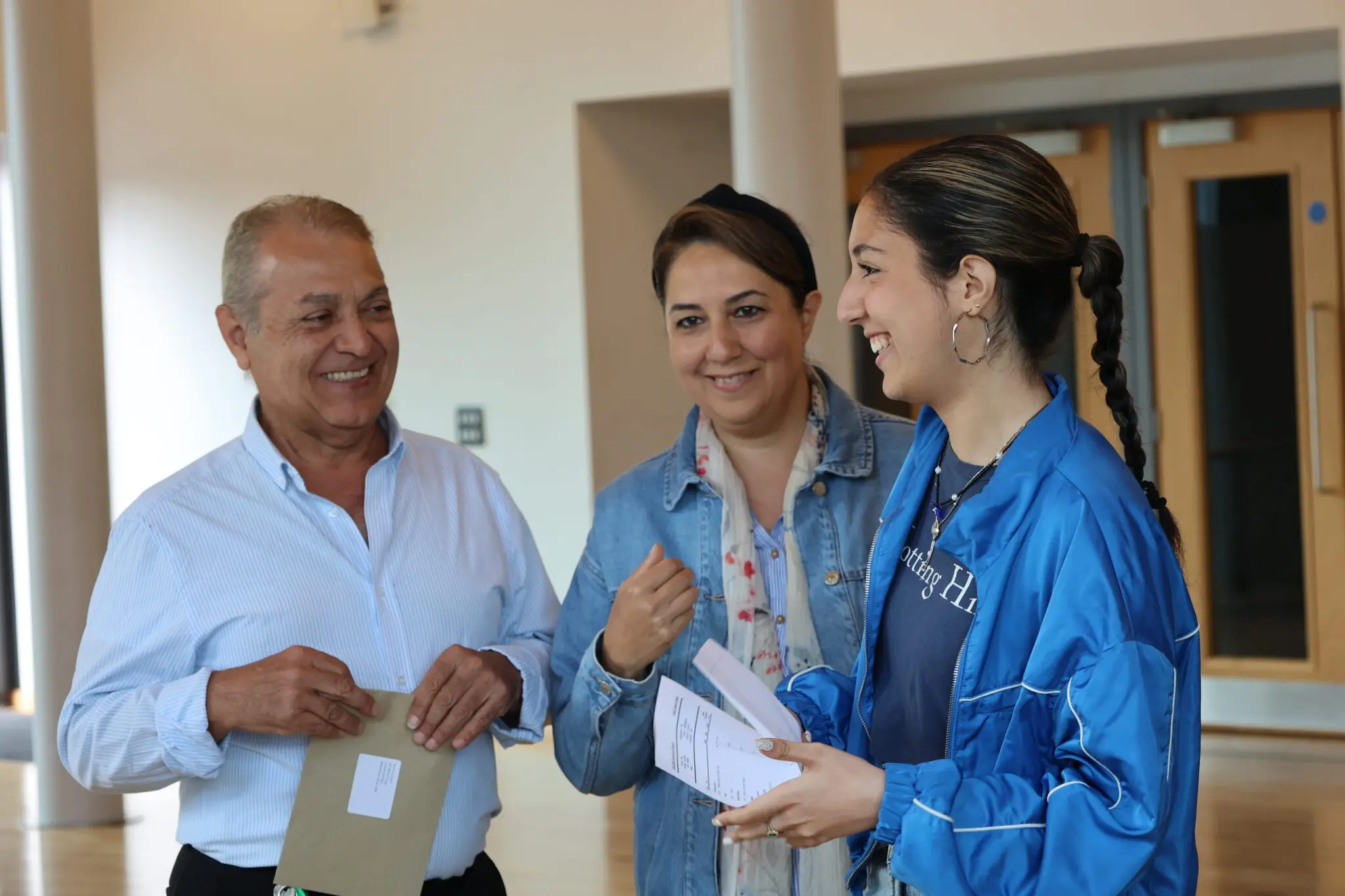 students celebrating results with parents