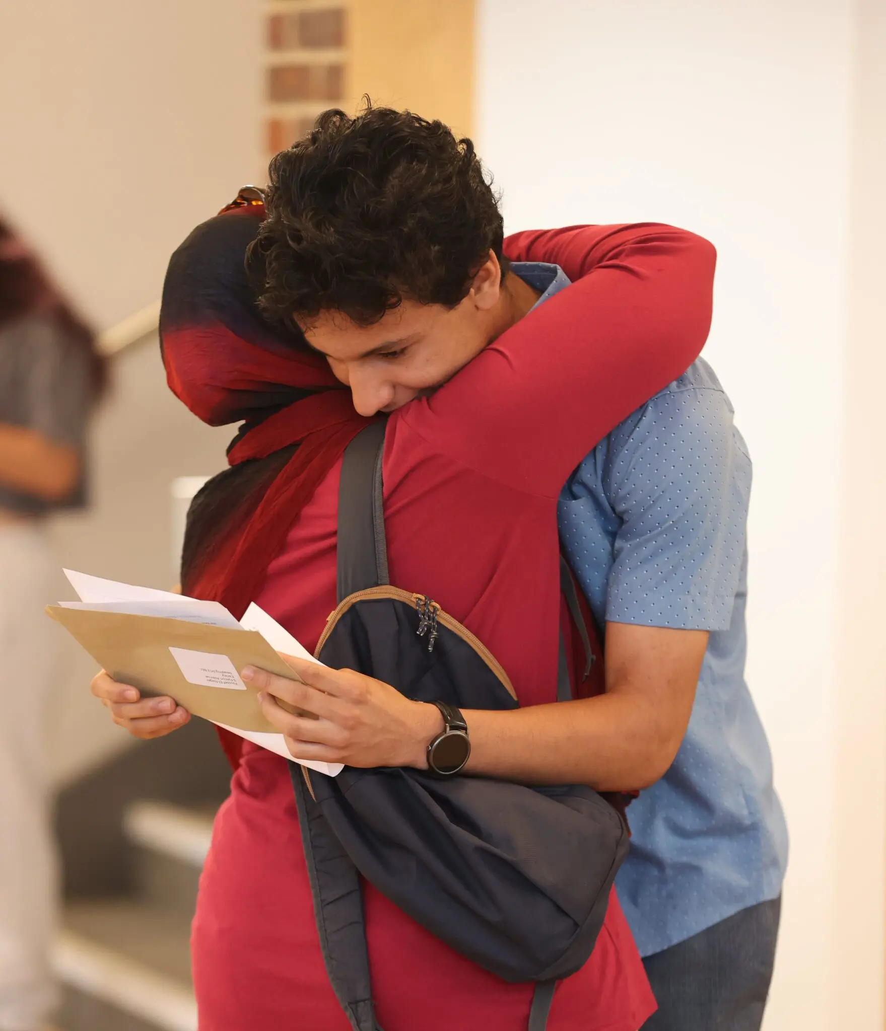 student embracing parent on results day