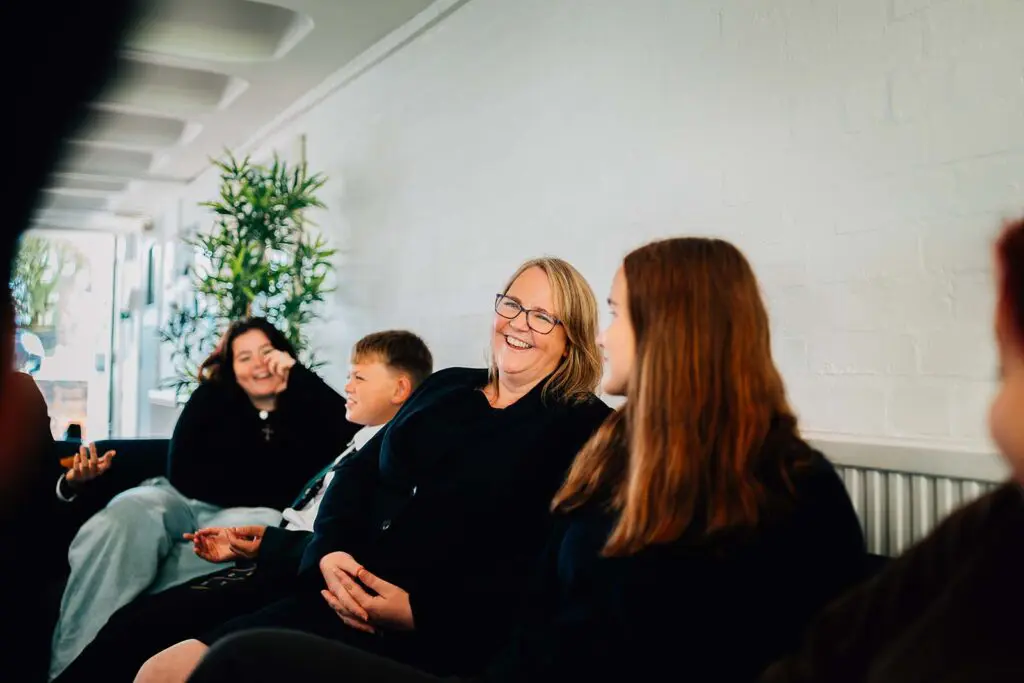 teacher laughing with students at Sibford