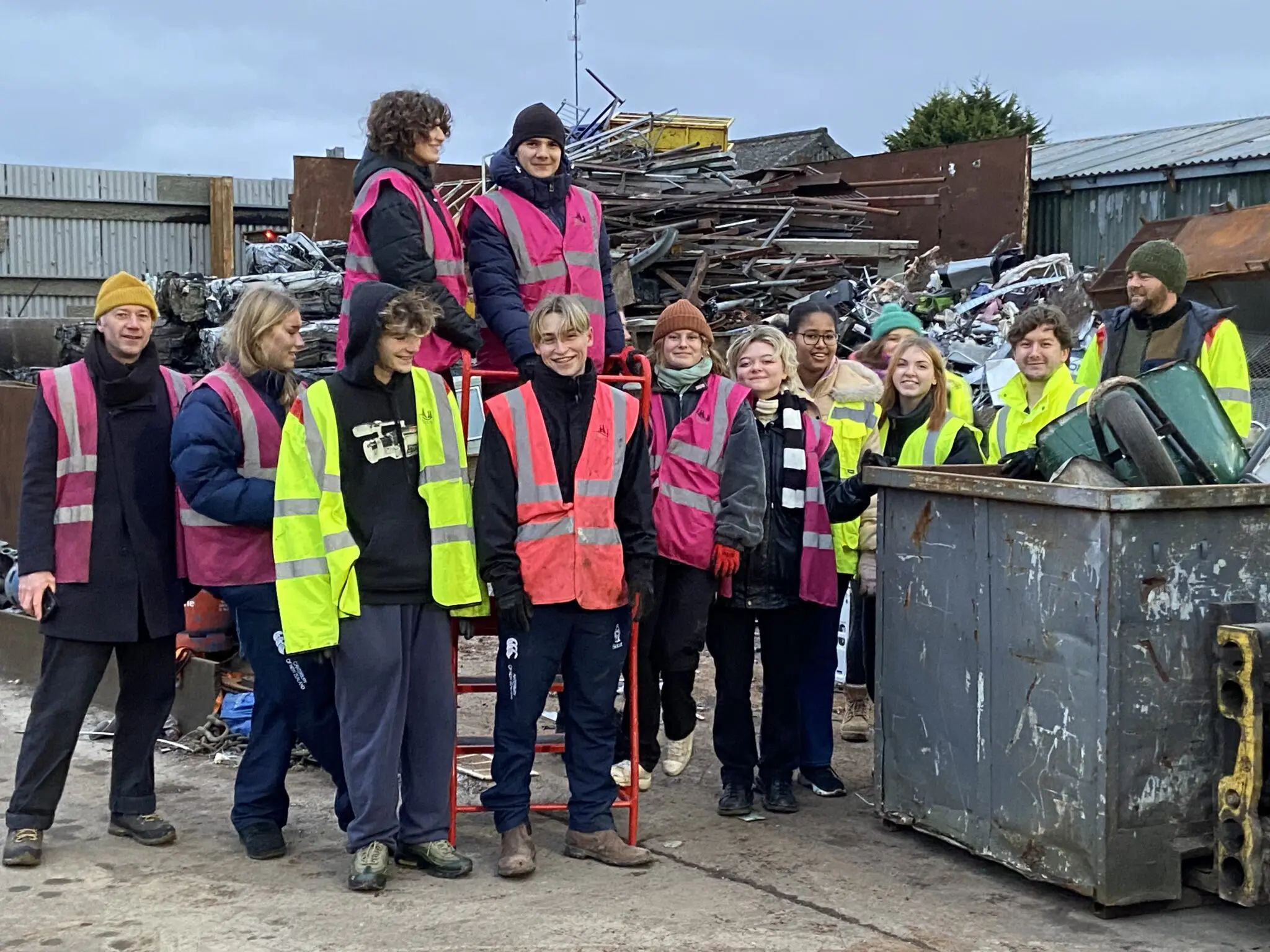 students in hi-vis ready to set up glastonbury festival art installation