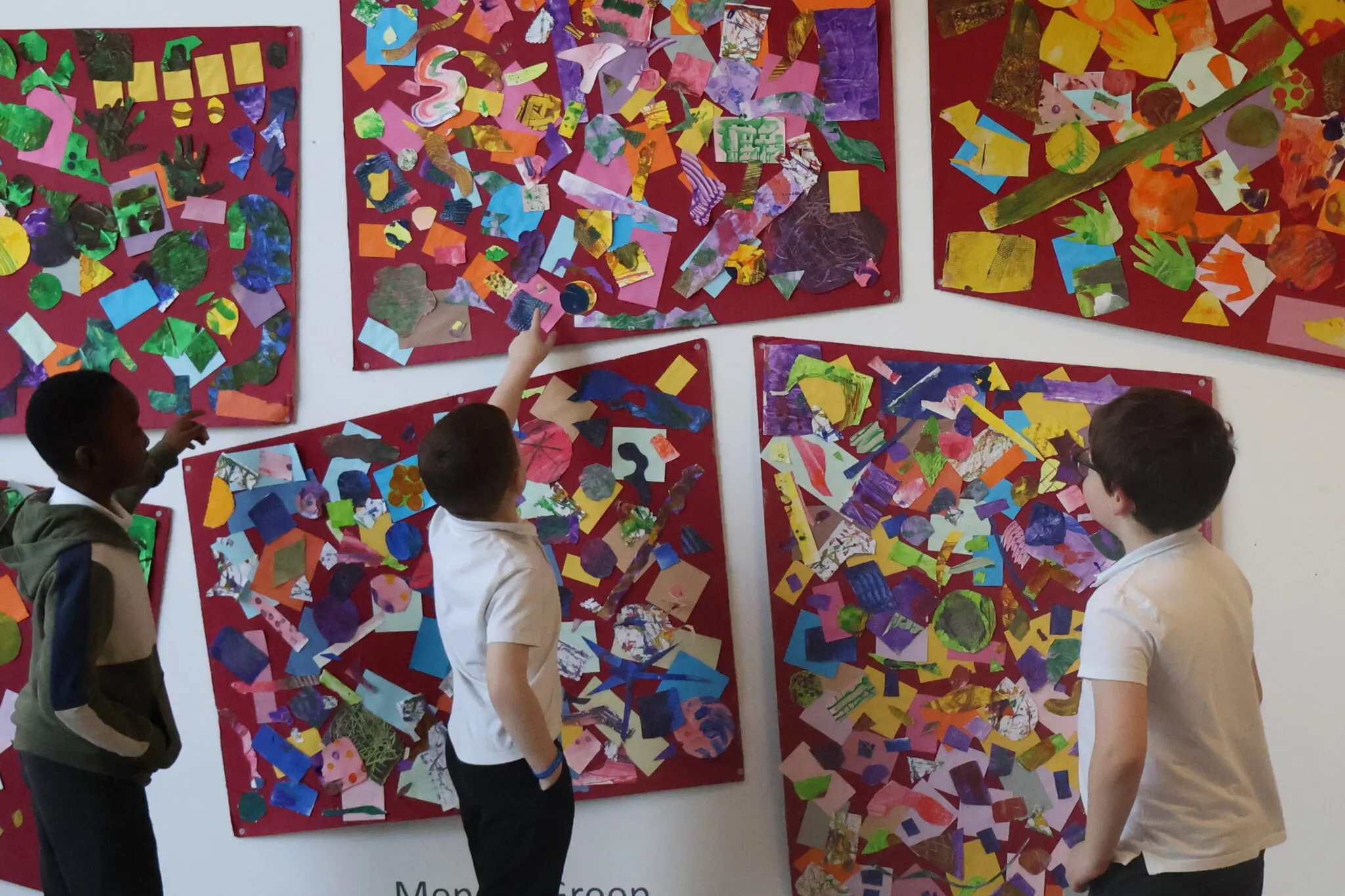 children looking at artwork on a classroom wall