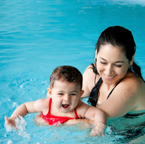 mother and baby in a swimming lesson