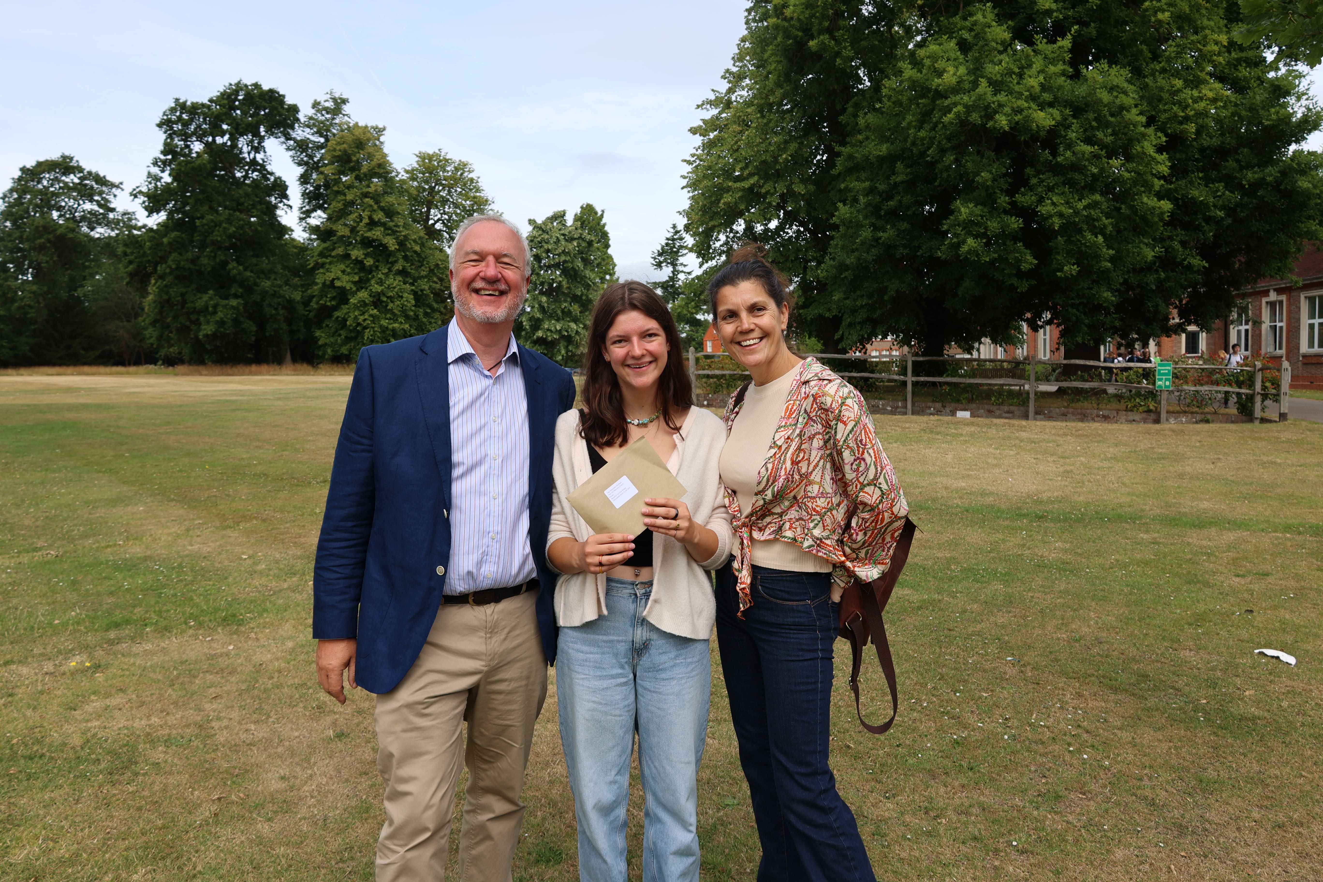 father, daughter and mother on IB results day