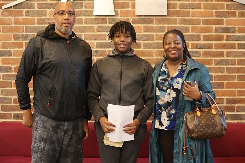 student with parents on GSCE results day