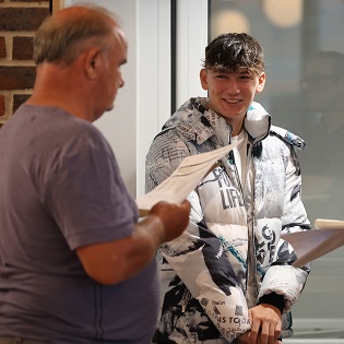student and father with GSCE results 