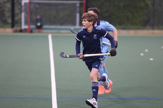 boys running on hockey astroturf 