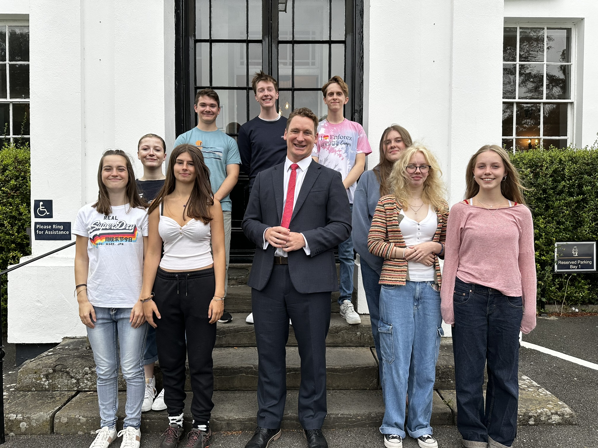 teacher and students celebrating 2024 gcses