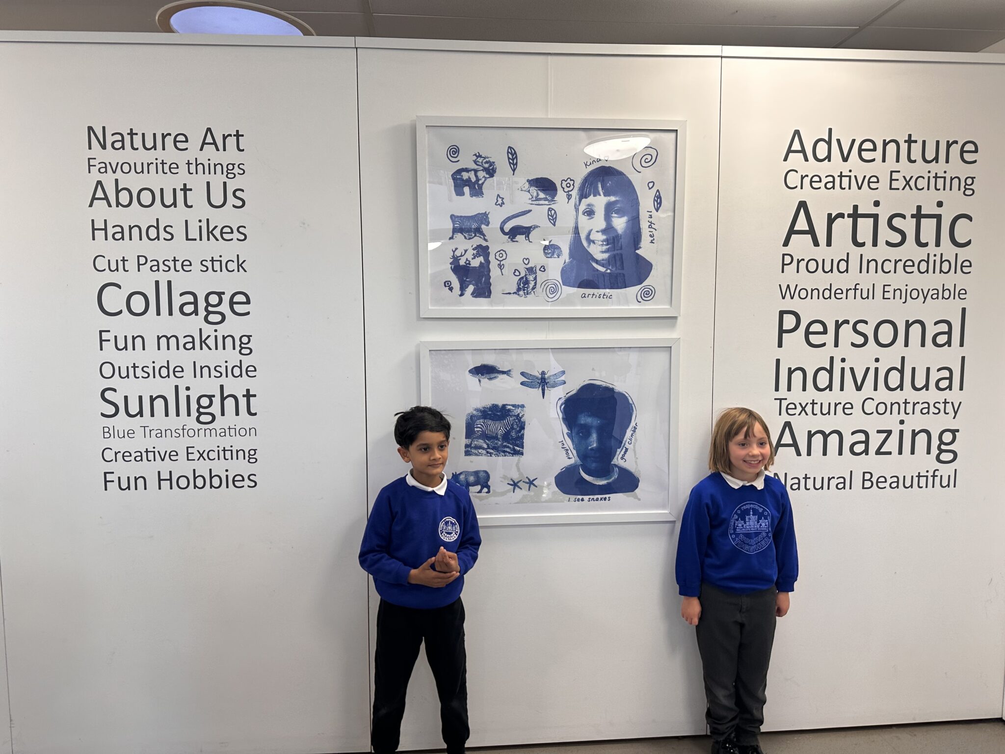 two students with their artwork in a gallery