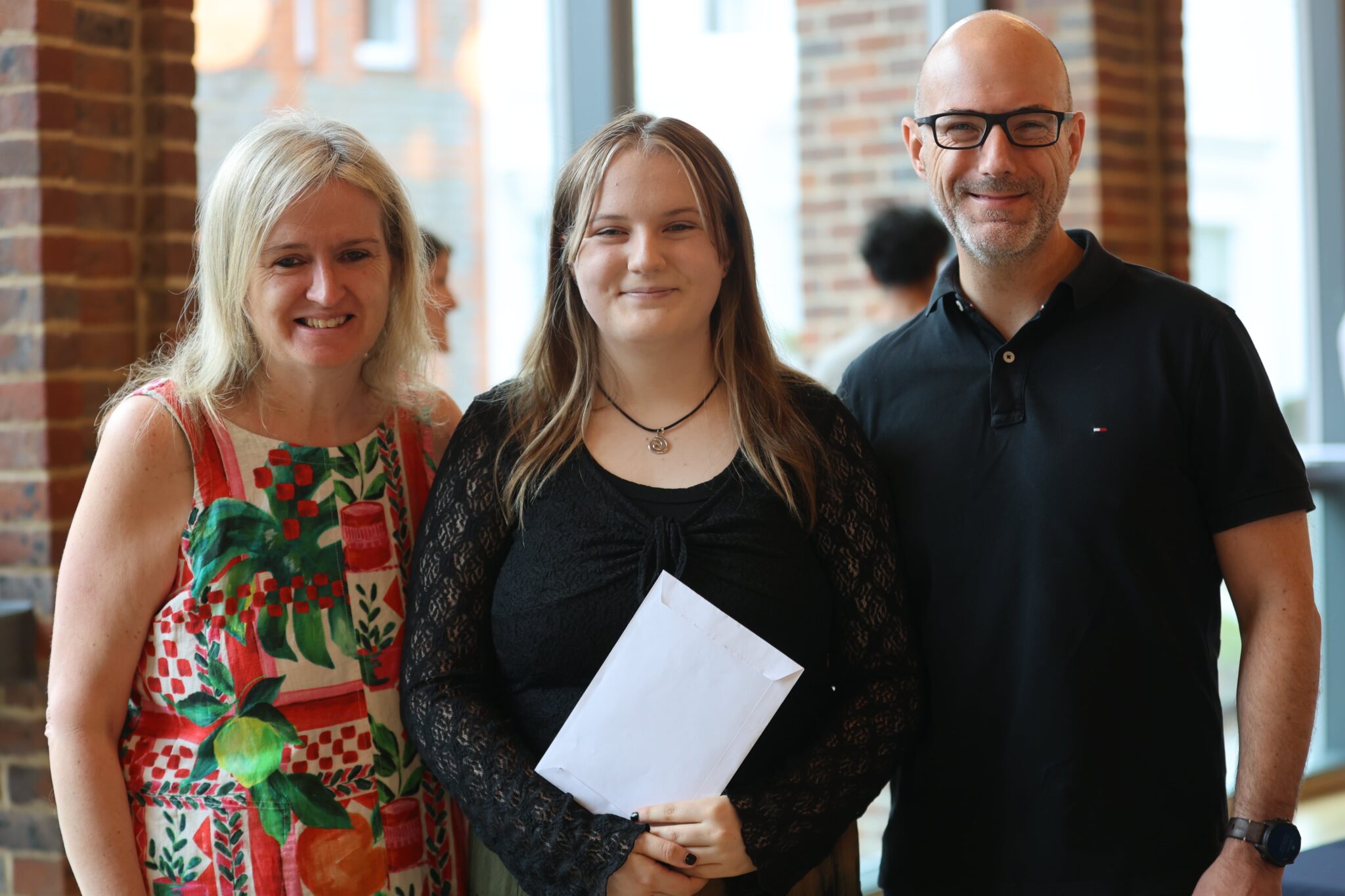 Parents with daughter on GCSE results day